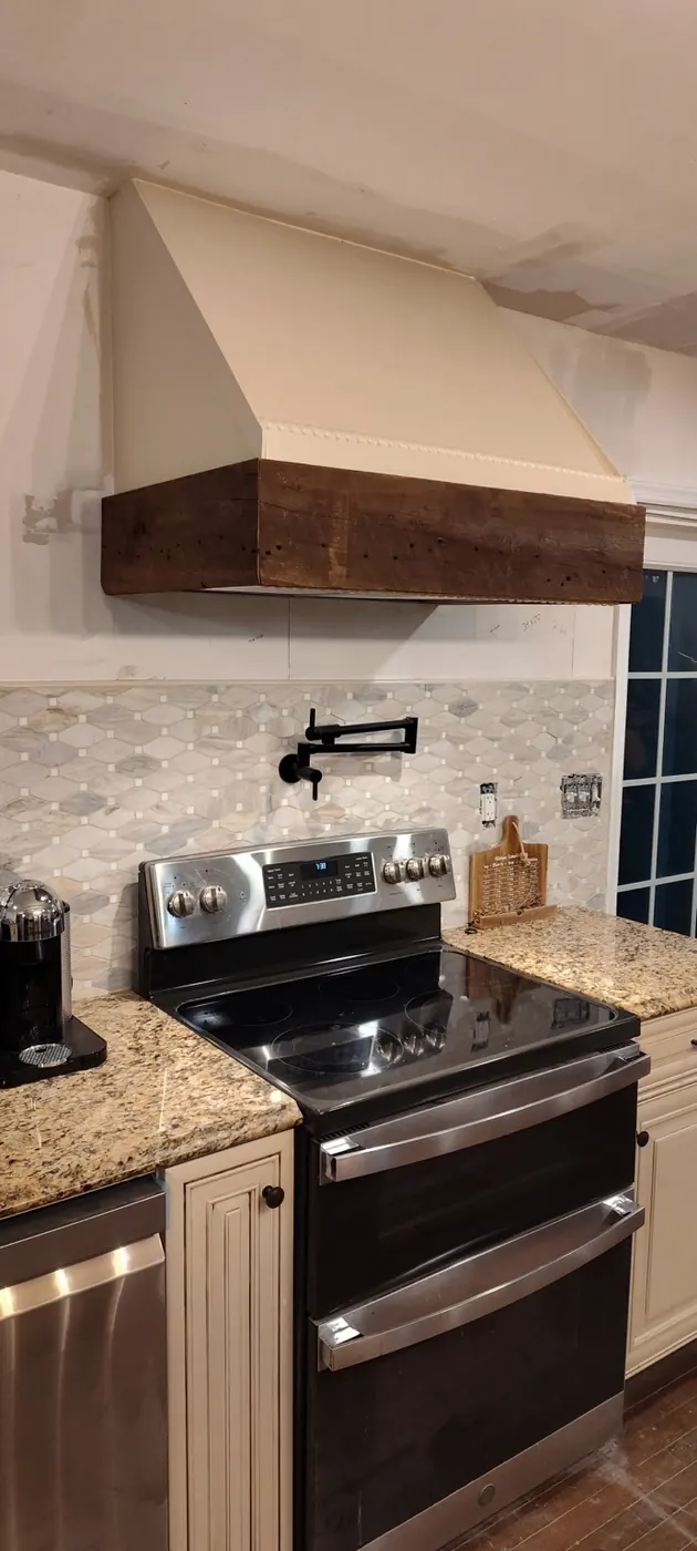 Custom range hood with reclaimed wood accent