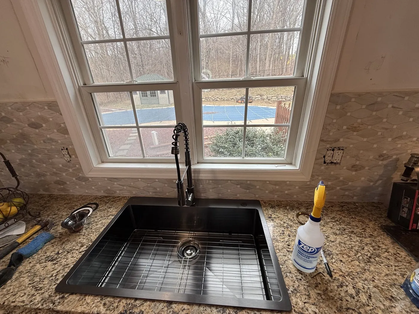 Detail of the finished black kitchen sink and faucet