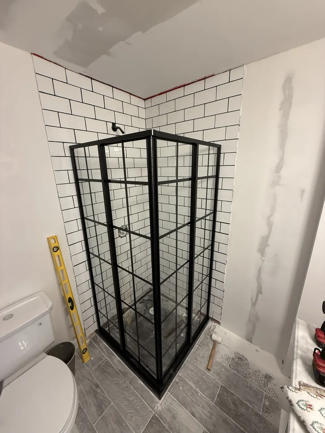 Black framed shower enclosure installation